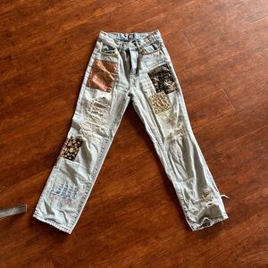 Urban Outfitters "Cowboy Jeans" size 26 with patchwork and rips.